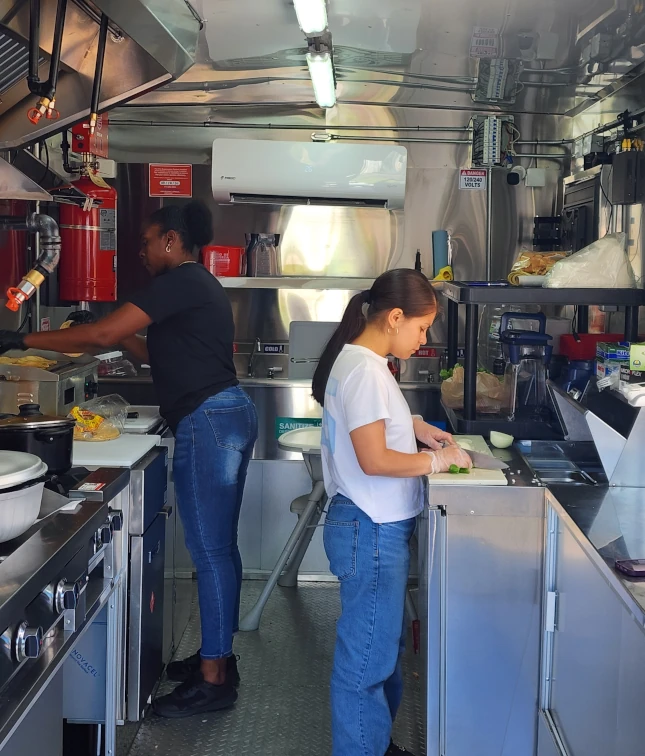 Chefs Cooking inside of truck